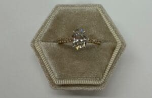 Diamond ring in hexagonal velvet box.