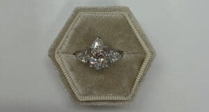 Diamond ring in hexagonal velvet box.