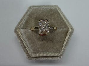 Diamond ring in hexagonal velvet box.