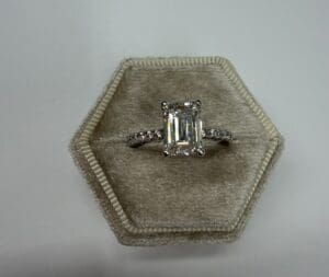 Emerald-cut diamond ring in hexagonal velvet box