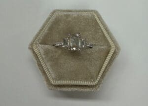 Emerald-cut diamond ring in hexagon velvet box