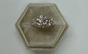 Three stone diamond ring in velvet box
