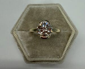 Gold band oval diamond ring in velvet box
